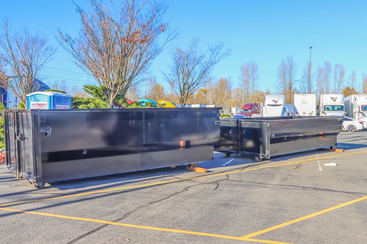 Professional dumpster rental service with roll-off container on residential driveway in Indian Harbour Beach